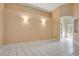 A spacious room with neutral walls, white tile flooring, and natural light from the front door at 7622 Hampshire Garden Pl, Apollo Beach, FL 33572