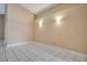 A spacious and bright room with neutral walls and white tile flooring, ready for customization at 7622 Hampshire Garden Pl, Apollo Beach, FL 33572