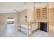 Open-concept kitchen with tile floors, custom shelving, and views of the backyard at 7622 Hampshire Garden Pl, Apollo Beach, FL 33572