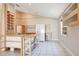 Spacious kitchen with custom shelving, white appliances, and tile flooring at 7622 Hampshire Garden Pl, Apollo Beach, FL 33572