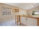 Kitchen featuring wood-top countertops, white cabinets, tile floors, and plenty of natural light at 7622 Hampshire Garden Pl, Apollo Beach, FL 33572