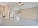 Bright and airy living room with tile flooring and a ceiling fan at 7622 Hampshire Garden Pl, Apollo Beach, FL 33572