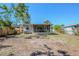 Back exterior of a home with a screened-in porch and fenced backyard at 1542 39 S St, St Petersburg, FL 33711