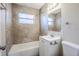 Bathroom showcasing a tiled shower, vanity, and a framed mirror at 1542 39 S St, St Petersburg, FL 33711