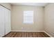 Bedroom features a closet with sliding doors, wood-look flooring, and a window at 1542 39 S St, St Petersburg, FL 33711