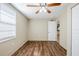 Comfortable bedroom showcasing wood-look floors, a ceiling fan, and a window at 1542 39 S St, St Petersburg, FL 33711