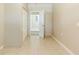 A hallway with neutral colored walls and flooring featuring an open doorway at 1542 39 S St, St Petersburg, FL 33711