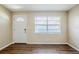 Neutral living room with new laminate floors, front door and large window at 1542 39 S St, St Petersburg, FL 33711