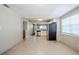 Open layout to this living room and kitchen area with white cabinets and stainless appliances at 1542 39 S St, St Petersburg, FL 33711