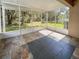 Enclosed screened porch with tile flooring, offering a peaceful outdoor living space at 18233 Portside St, Tampa, FL 33647