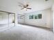 Light-filled bedroom with large mirrored closet doors and neutral carpeting at 1827 E Leewynn Dr, Sarasota, FL 34240