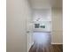 Hallway leading to living room featuring wood floors and a ceiling fan at 1827 E Leewynn Dr, Sarasota, FL 34240