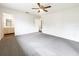 Neutral main bedroom with ceiling fan and doorway to main bathroom at 1827 E Leewynn Dr, Sarasota, FL 34240