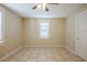 Bedroom featuring tile floors, a ceiling fan, and natural light from a window at 2011 10Th S St, St Petersburg, FL 33705