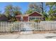 Inviting brick home with a classic white picket fence enhancing its curb appeal at 2011 10Th S St, St Petersburg, FL 33705
