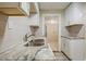 Updated kitchen with stainless steel sink, stone countertops, and white cabinetry at 2011 10Th S St, St Petersburg, FL 33705