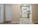 A charming kitchen area with white cabinets, stainless steel appliances, and an arched entrance at 2011 10Th S St, St Petersburg, FL 33705