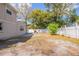Large backyard featuring mature trees and a white fence, with partial shade and a fire pit at 3207 N 45Th St, Tampa, FL 33605
