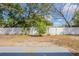 Spacious backyard with a white fence and mature trees, perfect for outdoor enjoyment at 3207 N 45Th St, Tampa, FL 33605