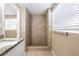 Bathroom featuring a tiled shower with updated fixtures and a window at 3207 N 45Th St, Tampa, FL 33605