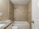 Updated bathroom featuring tiled shower-over-tub with granite vanity and modern fixtures at 3207 N 45Th St, Tampa, FL 33605