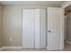 Bedroom featuring double bi-fold closet doors and an interior door for privacy at 3207 N 45Th St, Tampa, FL 33605