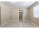 Neutral bedroom featuring tile floor, window, and doorway at 3207 N 45Th St, Tampa, FL 33605
