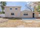 Two story home with a textured exterior, newly finished patio, and a dark front door at 3207 N 45Th St, Tampa, FL 33605