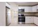 Well-lit kitchen with stainless steel appliances and white cabinets at 3207 N 45Th St, Tampa, FL 33605