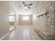 Bright living room featuring a stone fireplace and ceiling fan at 3207 N 45Th St, Tampa, FL 33605