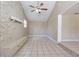 Bright living room featuring a stone fireplace and ceiling fan at 3207 N 45Th St, Tampa, FL 33605