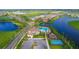 Aerial view of community amenities: clubhouse, pool, playground, sports court, lakes and homes at 4541 Mondrian Ct, Sarasota, FL 34240