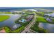 Aerial view of the community with clubhouse, pool, lakes, and well-manicured lawns at 4541 Mondrian Ct, Sarasota, FL 34240