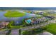 Overhead view of community clubhouse, pool, and tennis courts near lakefront homes at 4541 Mondrian Ct, Sarasota, FL 34240