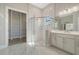 Luxurious bathroom with glass shower, walk-in closet, marble flooring, and white vanity at 4541 Mondrian Ct, Sarasota, FL 34240