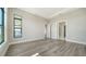 Bright bedroom featuring large windows and connecting doors to other rooms with modern laminate flooring throughout at 4541 Mondrian Ct, Sarasota, FL 34240