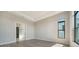 Serene bedroom with modern recessed lighting, large windows, and adjacent bathroom with glass shower at 4541 Mondrian Ct, Sarasota, FL 34240