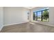 Bright bedroom with large windows and a scenic view, complemented by stylish and durable light wood flooring at 4541 Mondrian Ct, Sarasota, FL 34240