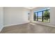 Bedroom with large windows offering a waterfront view, complemented by modern gray walls and beautiful laminate flooring at 4541 Mondrian Ct, Sarasota, FL 34240