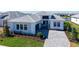 Beautiful single-story home featuring a paver driveway, manicured lawn, and a modern white exterior at 4541 Mondrian Ct, Sarasota, FL 34240