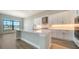 Well-lit kitchen features stainless steel appliances, a kitchen island, and a large window for natural light and views of the backyard at 4541 Mondrian Ct, Sarasota, FL 34240