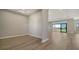 Open-concept living room with light wood floors, recessed lighting, and large windows overlooking the backyard at 4541 Mondrian Ct, Sarasota, FL 34240