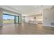 Open-concept living room with wood floors and a large sliding glass door to the lanai at 4541 Mondrian Ct, Sarasota, FL 34240