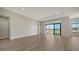 Living room featuring wood flooring, recessed lighting, and sliding glass doors at 4541 Mondrian Ct, Sarasota, FL 34240