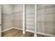 Spacious walk-in closet featuring stylish wood floors and ample white wire shelving for storage at 4541 Mondrian Ct, Sarasota, FL 34240