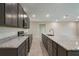 Bright kitchen with stainless steel appliances, granite countertops, a central island, and gray cabinets at 51 Independence St, Port Charlotte, FL 33954
