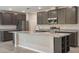 Modern kitchen featuring gray cabinets, stainless steel appliances, granite countertops, and a large island at 51 Independence St, Port Charlotte, FL 33954