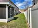 Exterior view of fenced backyard and screened-in patio at 523 Glenn Cross Dr, Ruskin, FL 33570