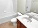 Clean bathroom featuring a vanity with a sink, a toilet, and a bathtub with a shower, designed for convenience at 523 Glenn Cross Dr, Ruskin, FL 33570