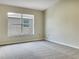 Bright bedroom with neutral walls and large window, showcasing a clean and well-lit space at 523 Glenn Cross Dr, Ruskin, FL 33570